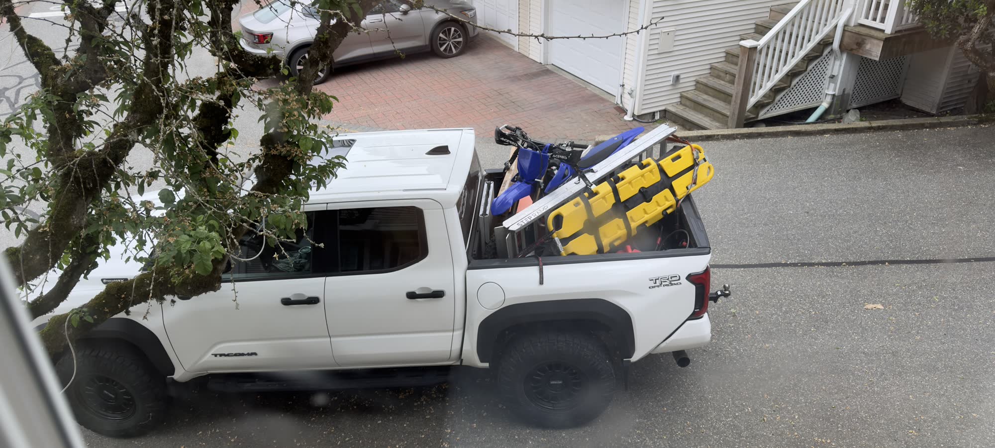 A pickup truck loaded with a rescue stretcher, spine board and a dirt bike, ready to deploy.